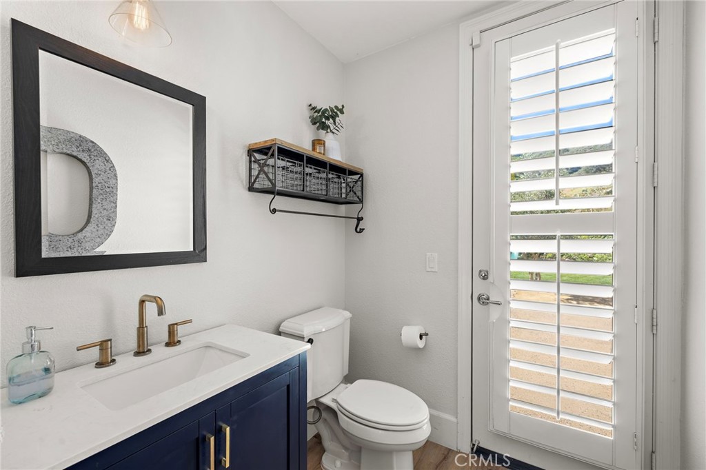 21 Snow Bush Street Ladera Ranch, CA 92694 - Photo 36 of 73 a bathroom with a toilet a sink a vanity a window and mirror