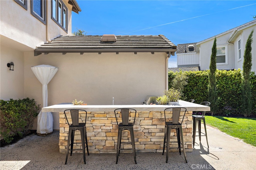 21 Snow Bush Street Ladera Ranch, CA 92694 - Photo 39 of 73 a view of a patio with table and chairs and potted plants