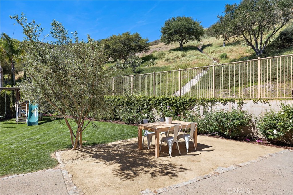 21 Snow Bush Street Ladera Ranch, CA 92694 - Photo 40 of 73 a view of a chairs and table in backyard