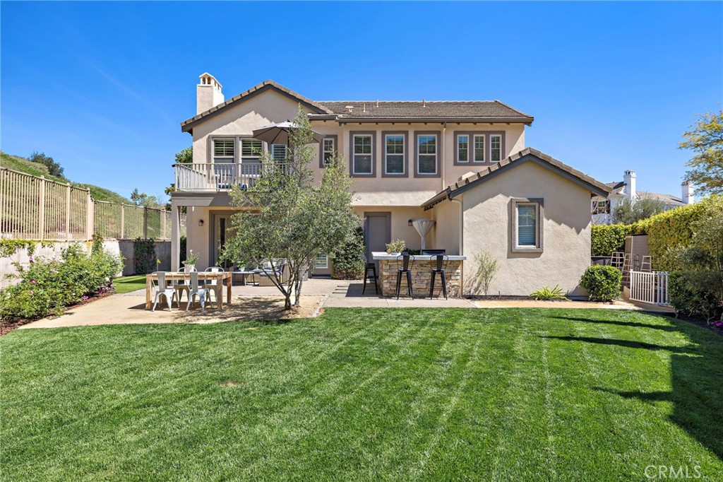 21 Snow Bush Street Ladera Ranch, CA 92694 - Photo 43 of 73 a front view of a house with backyard and sitting area