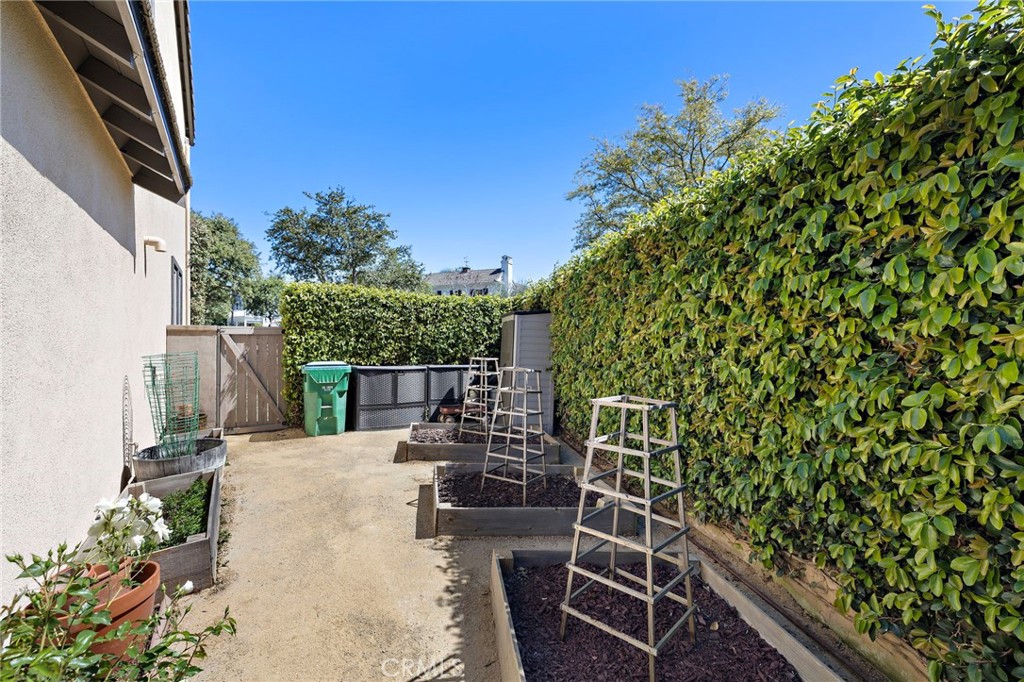 21 Snow Bush Street Ladera Ranch, CA 92694 - Photo 46 of 73 a view of a patio with table and chairs and potted plants with wooden floor and fence