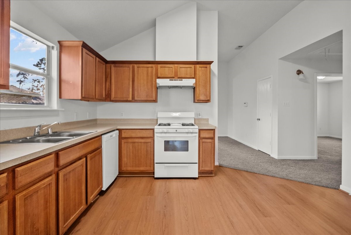 726 Flying Bridge Way Crosby, TX 77532 - Photo 12 of 32 a kitchen with stainless steel appliances a stove and white cabinets