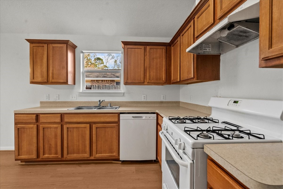 726 Flying Bridge Way Crosby, TX 77532 - Photo 9 of 32 a kitchen with granite countertop a sink stove and cabinets