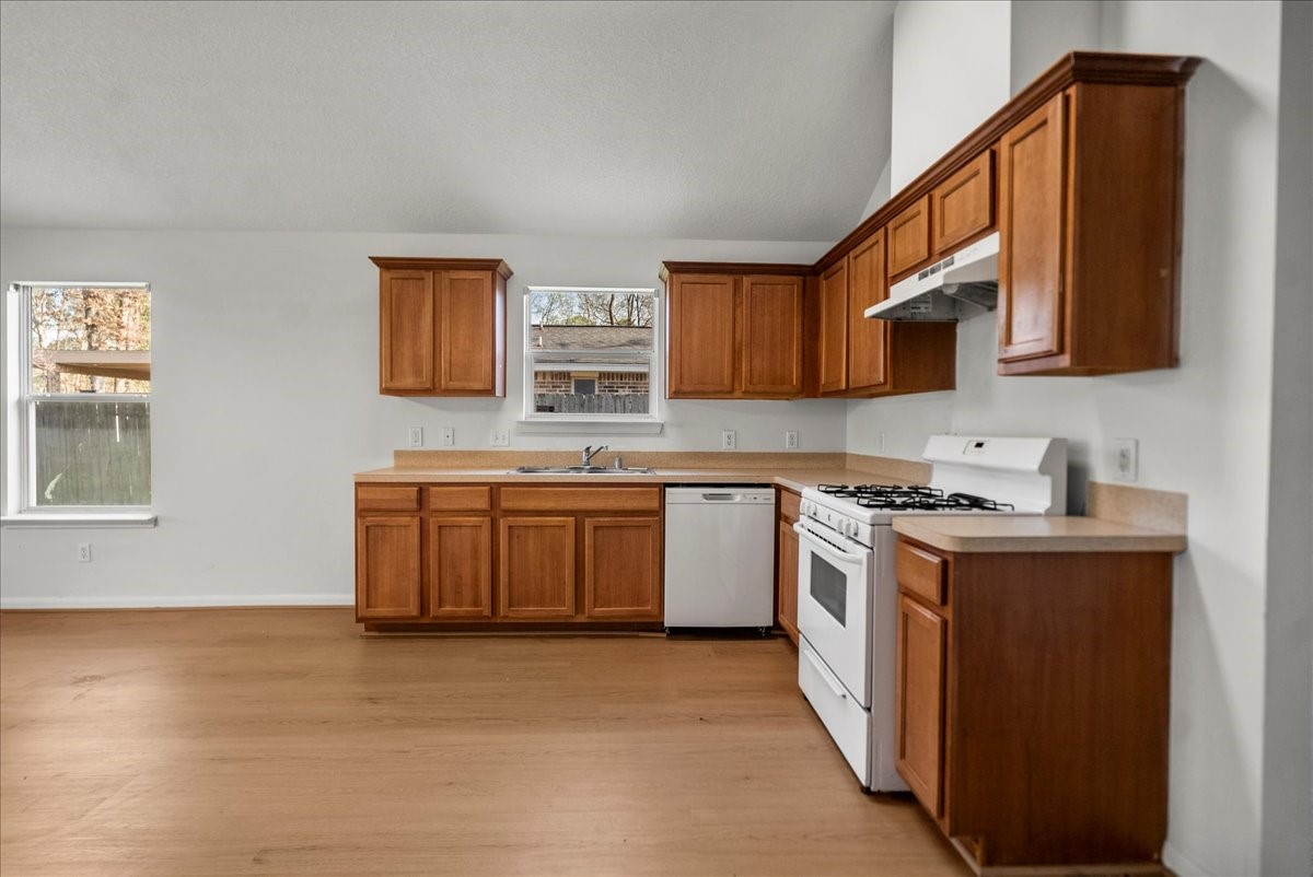 726 Flying Bridge Way Crosby, TX 77532 - Photo 10 of 32 a kitchen with stainless steel appliances a sink stove and cabinets