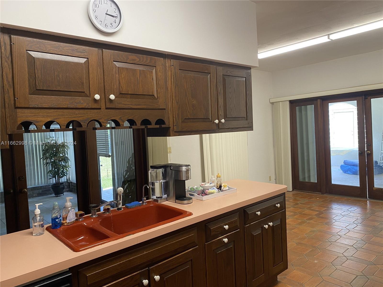 4450 Jog Road Lake Worth, FL 33467 - Photo 16 of 18 a kitchen with a sink and cabinets