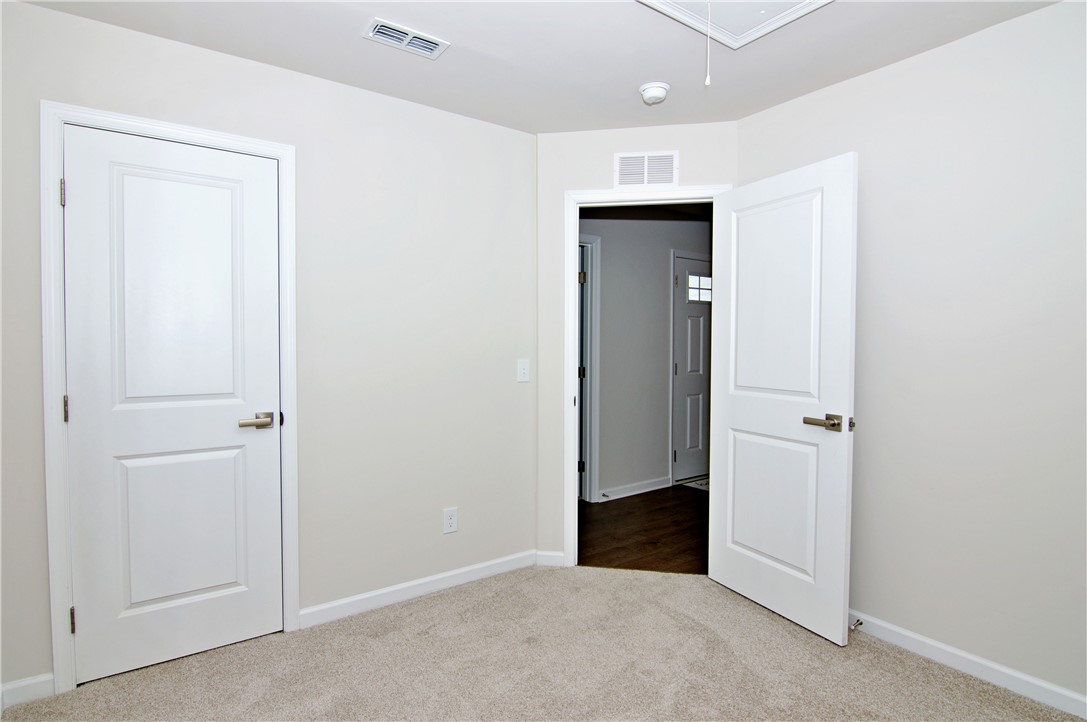 723 Peridot Way Westminster, SC 29693 - Photo 28 of 45 A quiet, carpeted room with neutral walls and pristine white doors awaits your personal touch.