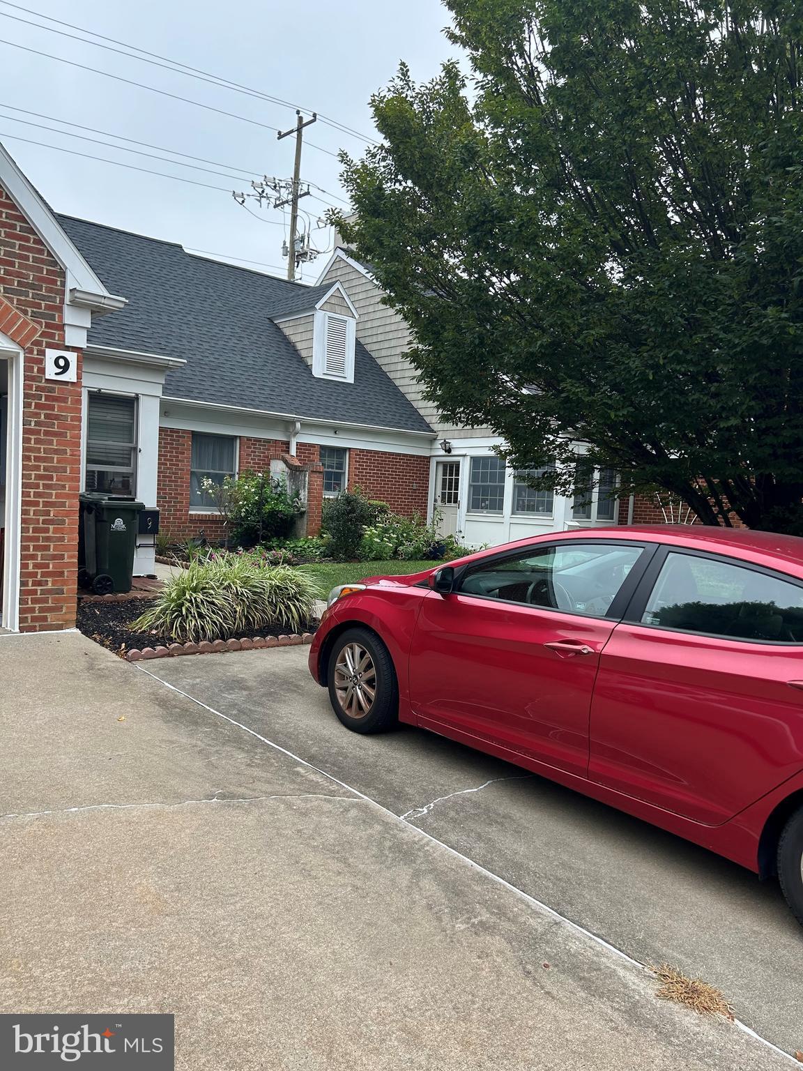 9 East Village Road, Unit 9 Newark, DE 19713 - Photo 1 of 14 a front view of a house with a garden
