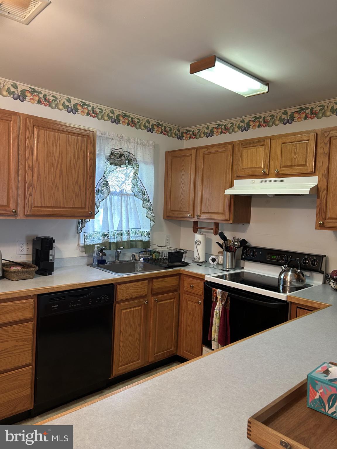 9 East Village Road, Unit 9 Newark, DE 19713 - Photo 5 of 14 a kitchen with granite countertop a sink dishwasher stove and cabinets