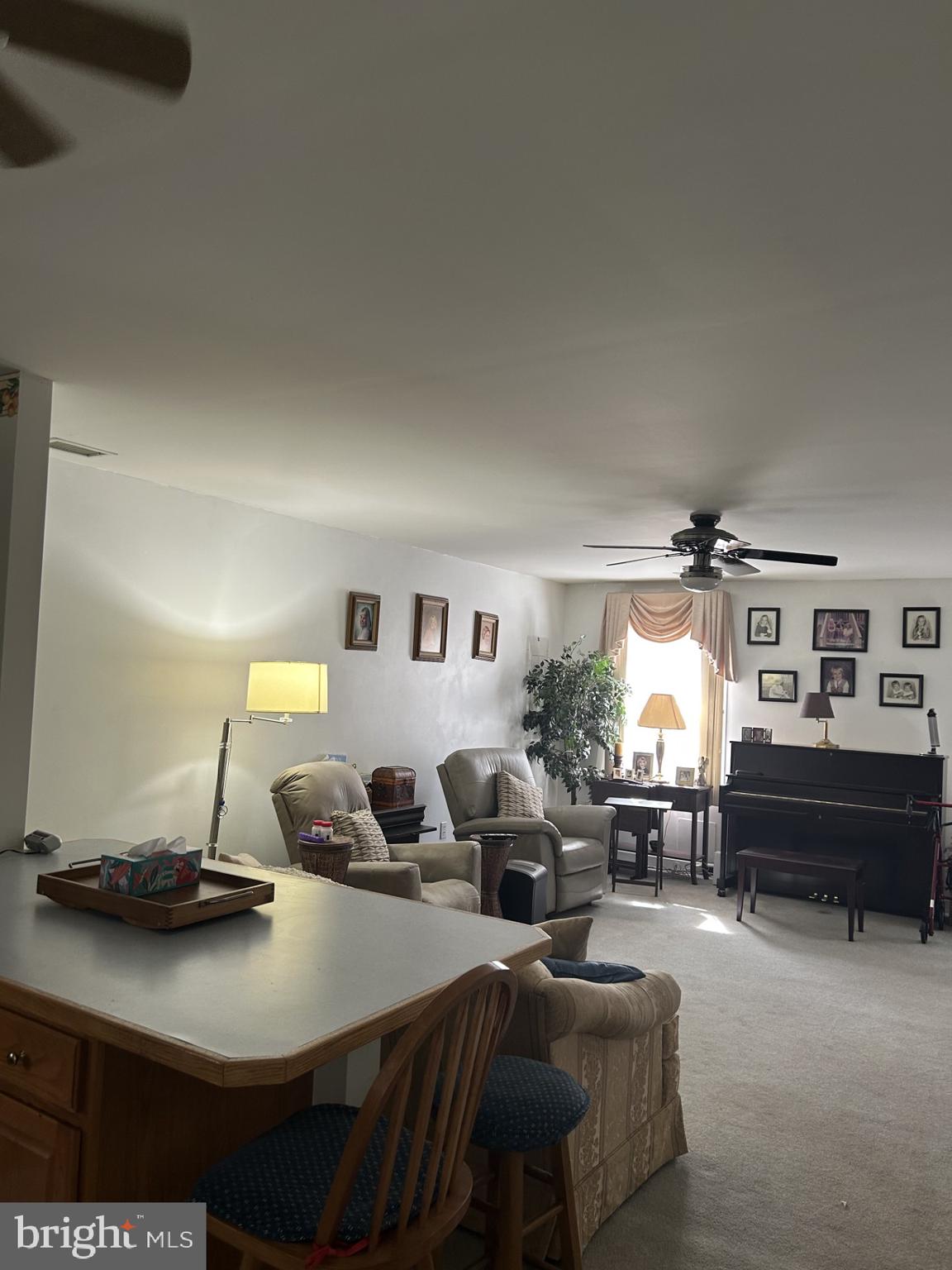 9 East Village Road, Unit 9 Newark, DE 19713 - Photo 10 of 14 a living room with furniture a piano and a fireplace