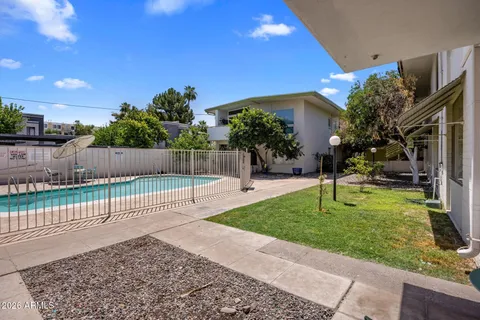 a view of a house with backyard porch and sitting area