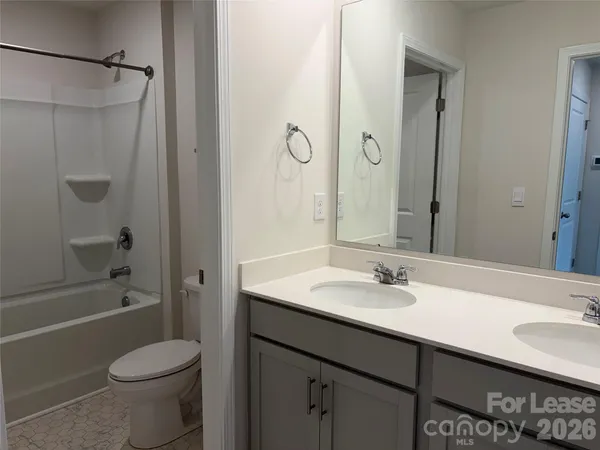 a bathroom with a sink toilet tub and shower