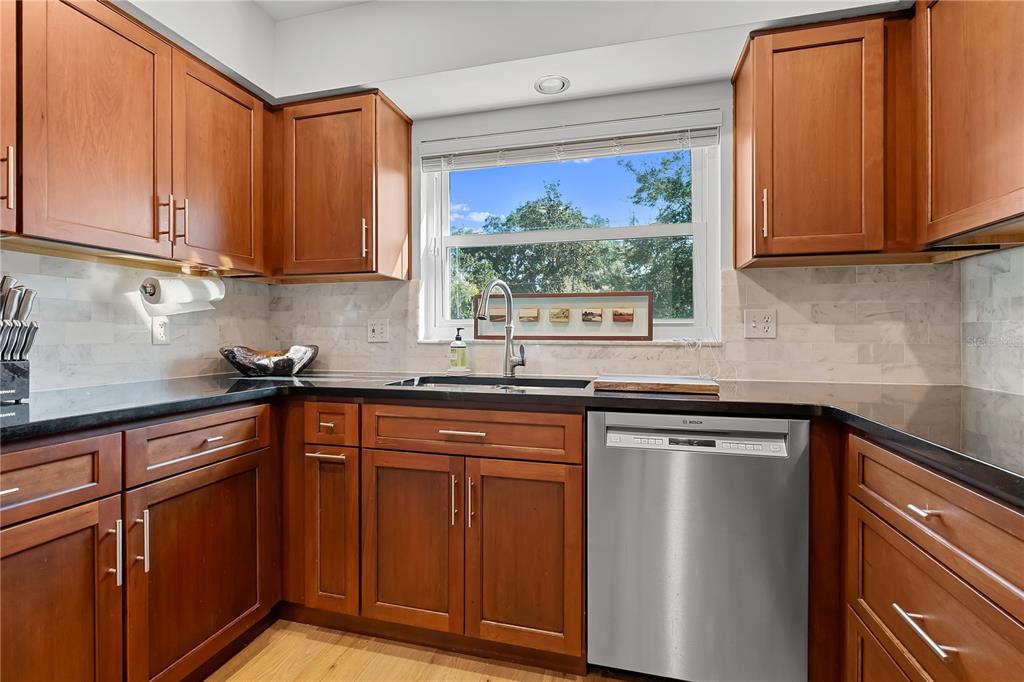 850 Juanita Rael Road Winter Park, FL 32789 - Photo 14 of 50 a kitchen with stainless steel appliances granite countertop white cabinets sink and a granite counter top