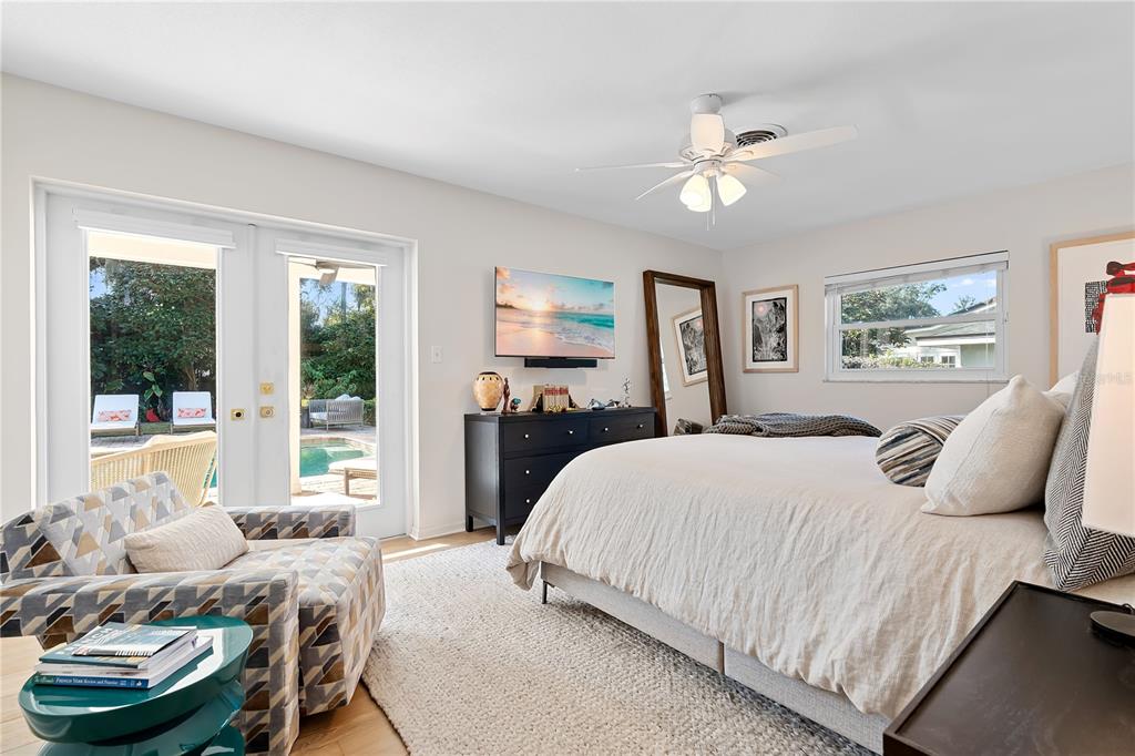 850 Juanita Rael Road Winter Park, FL 32789 - Photo 20 of 50 a bedroom with a bed and glass windows