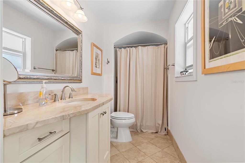 850 Juanita Rael Road Winter Park, FL 32789 - Photo 21 of 50 a bathroom with a granite countertop sink a toilet and a mirror