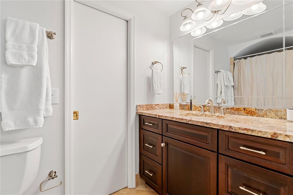 850 Juanita Rael Road Winter Park, FL 32789 - Photo 28 of 50 a bathroom with a granite countertop sink a toilet and a mirror