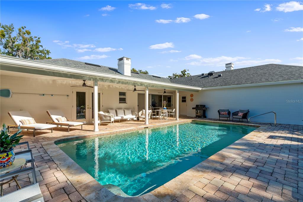 850 Juanita Rael Road Winter Park, FL 32789 - Photo 37 of 50 a view of a house with backyard sitting area and swimming pool