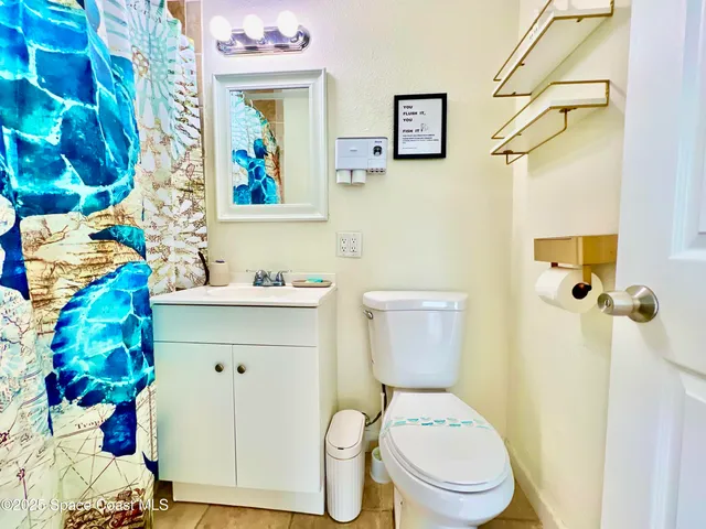a white toilet sitting next to a bathroom sink