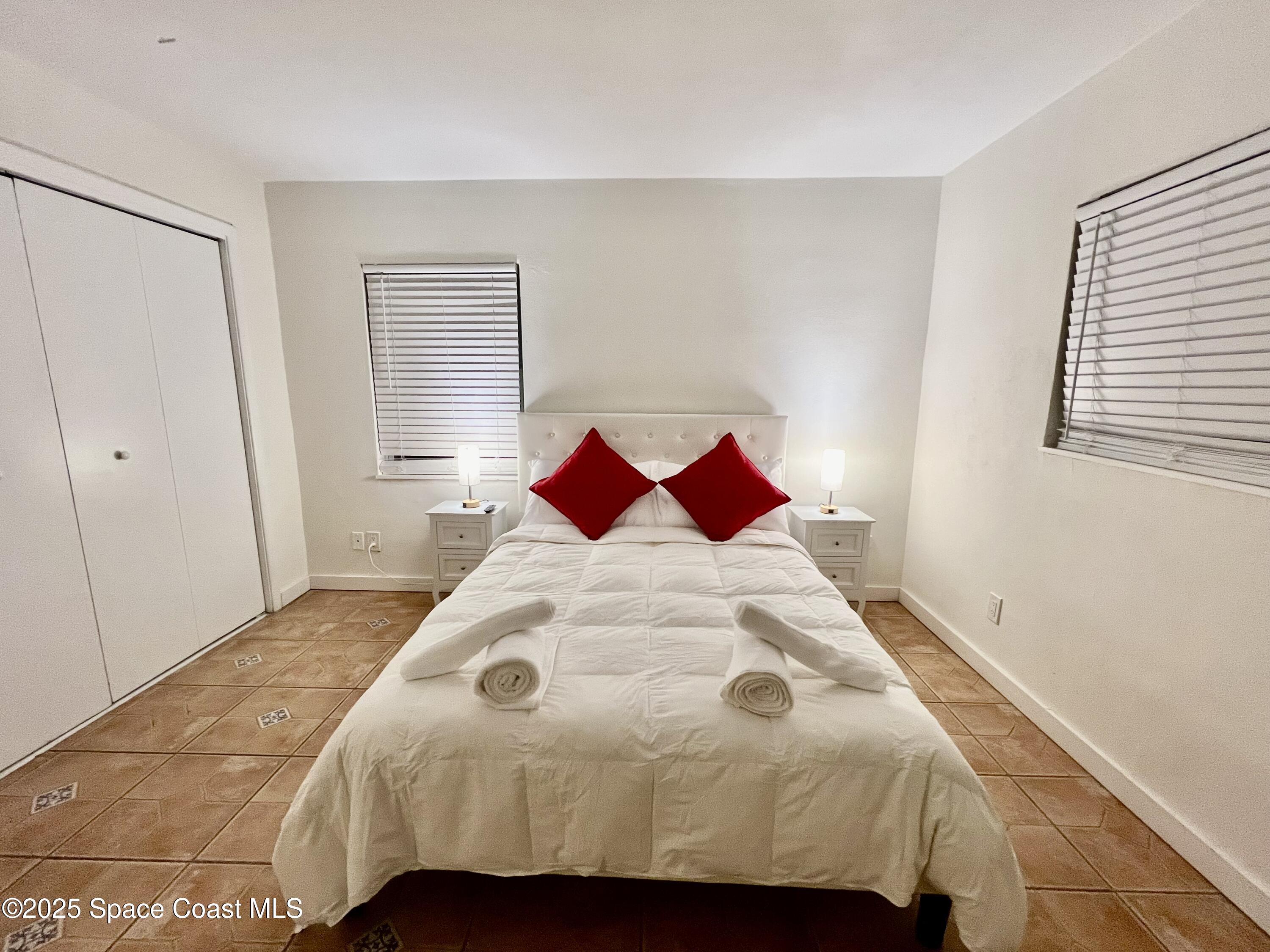 133 Northeast 1st Street Satellite Beach, FL 32937 - Photo 17 of 27 a bedroom with a bed and a window