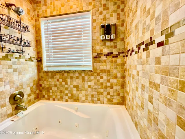 a bathroom with a bathtub and shower