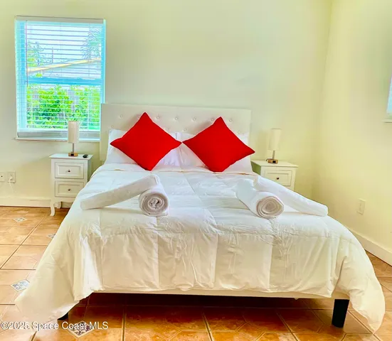 a bedroom with a bed and window