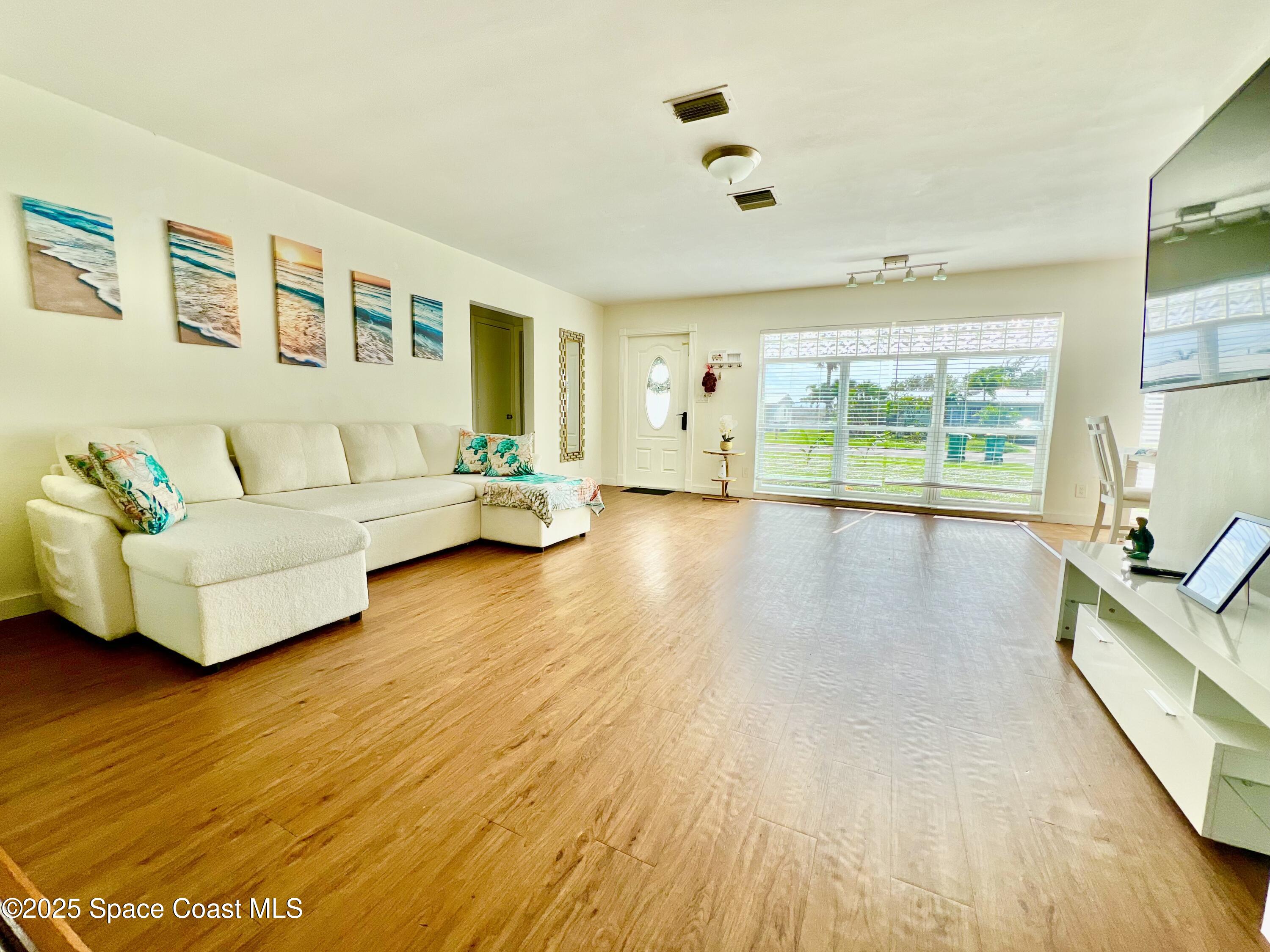 133 Northeast 1st Street Satellite Beach, FL 32937 - Photo 26 of 27 a living room with furniture and a large window