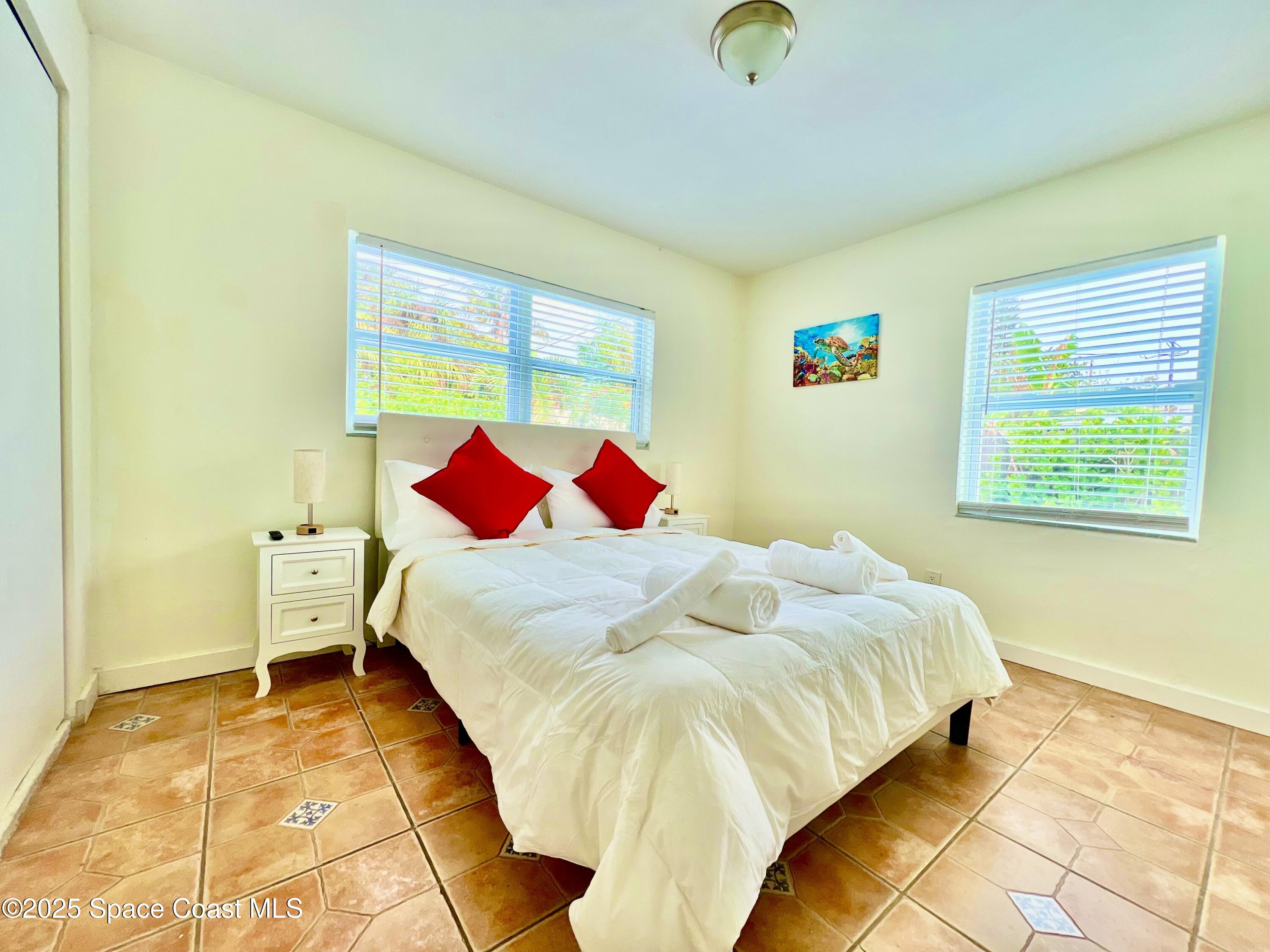 133 Northeast 1st Street Satellite Beach, FL 32937 - Photo 9 of 27 a bedroom with a bed and a painting on the wall