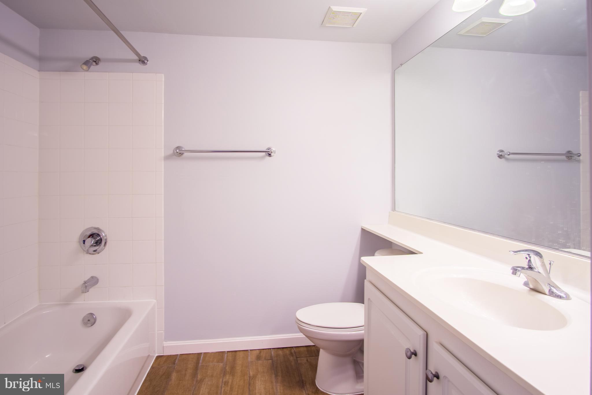 11710 Old Georgetown Road, Unit 422 North Bethesda, MD 20852 - Photo 13 of 29 a bathroom with a sink a toilet and a bathtub