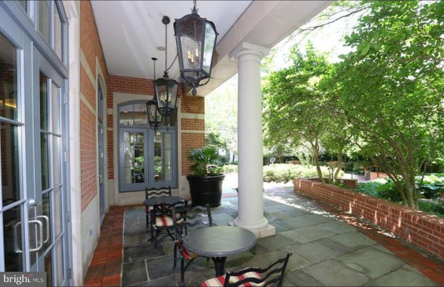 11710 Old Georgetown Road, Unit 422 North Bethesda, MD 20852 - Photo 23 of 29 a porch with chairs and table in patio