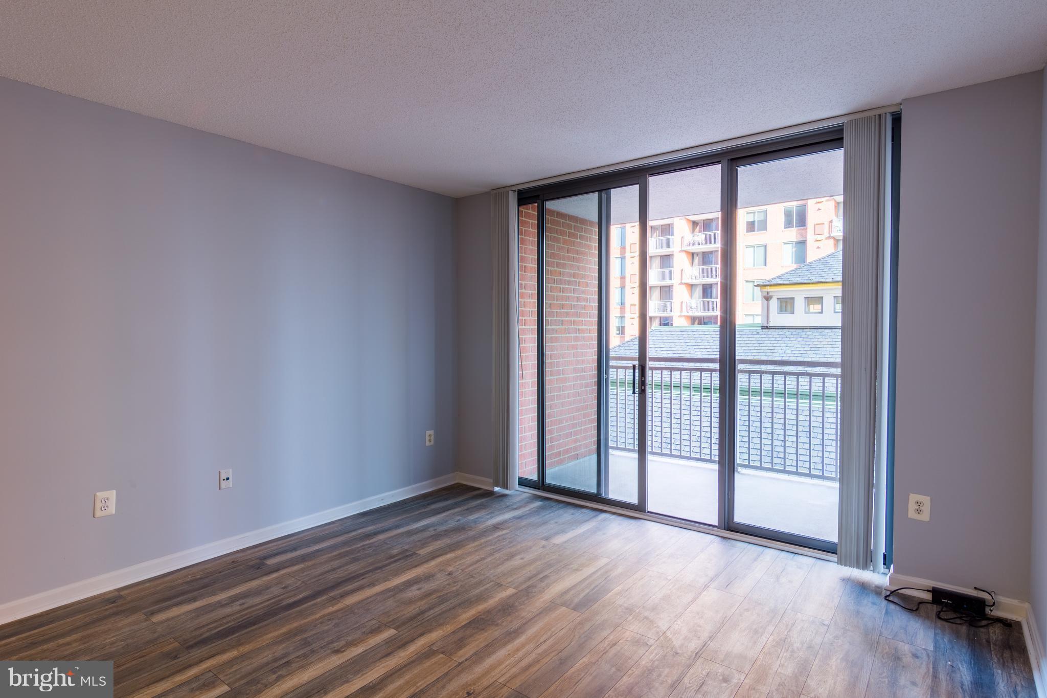 11710 Old Georgetown Road, Unit 422 North Bethesda, MD 20852 - Photo 9 of 29 wooden floor in an empty room with a window
