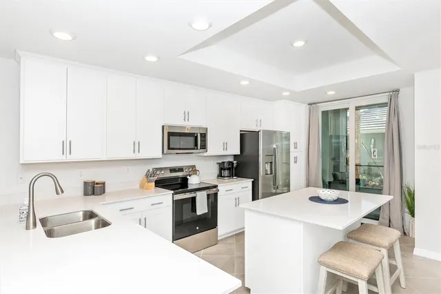 a living room with furniture a flat screen tv and a window