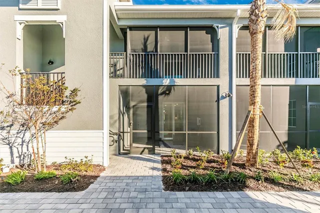 a open kitchen with stainless steel appliances granite countertop a refrigerator a stove a sink a dining table and chairs with wooden floor