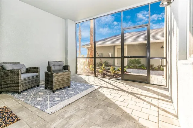 a kitchen with stainless steel appliances kitchen island granite countertop a refrigerator and a stove top oven with white cabinets