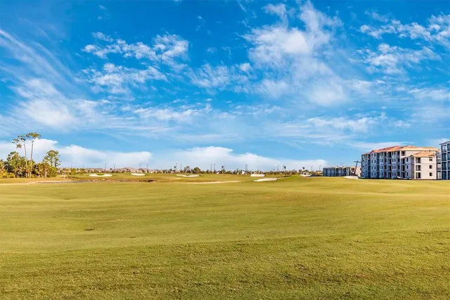 a dining room with lots of wooden furniture and a chandelier