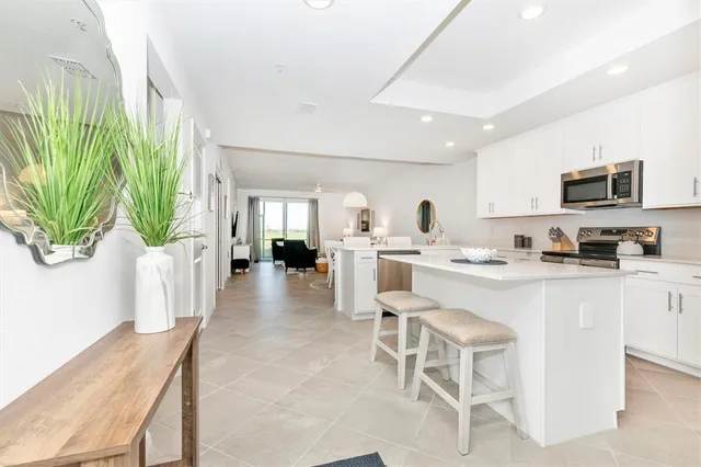 a living room with furniture a flat screen tv and a window