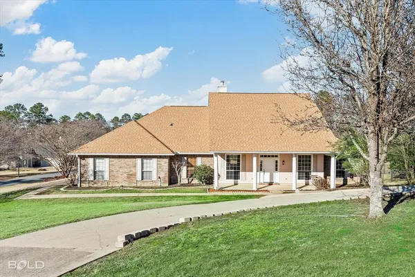 a front view of a house with a yard table and chairs