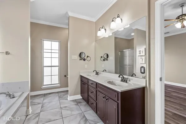 a bathroom with a sink a toilet and a large mirror