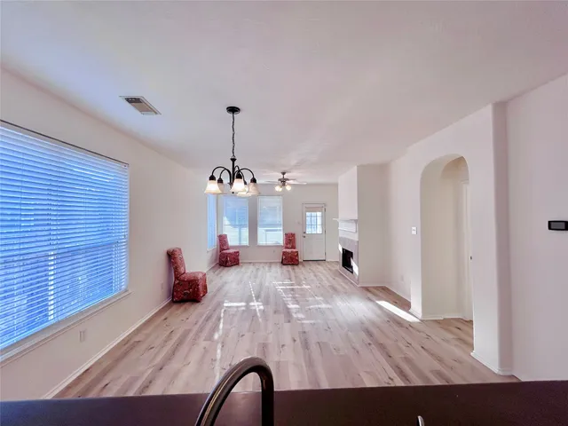 a view of a livingroom with furniture wooden floor and chandelier