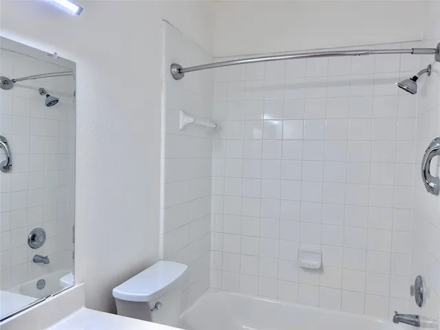 a bathroom with a shower and a toilet