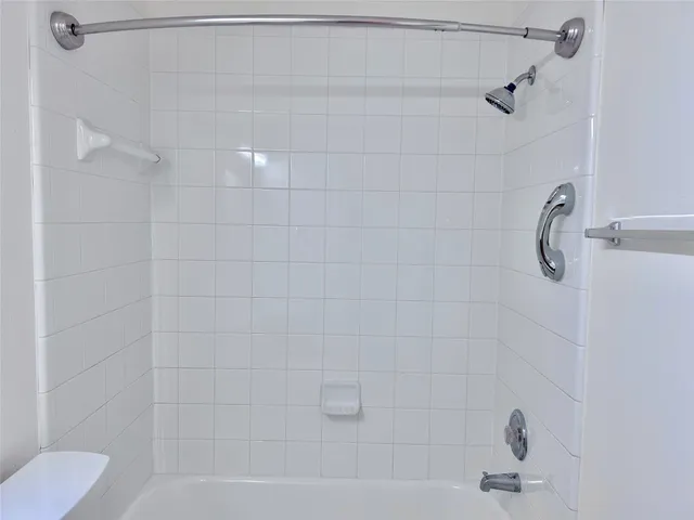 a bathroom with a shower and a bathtub