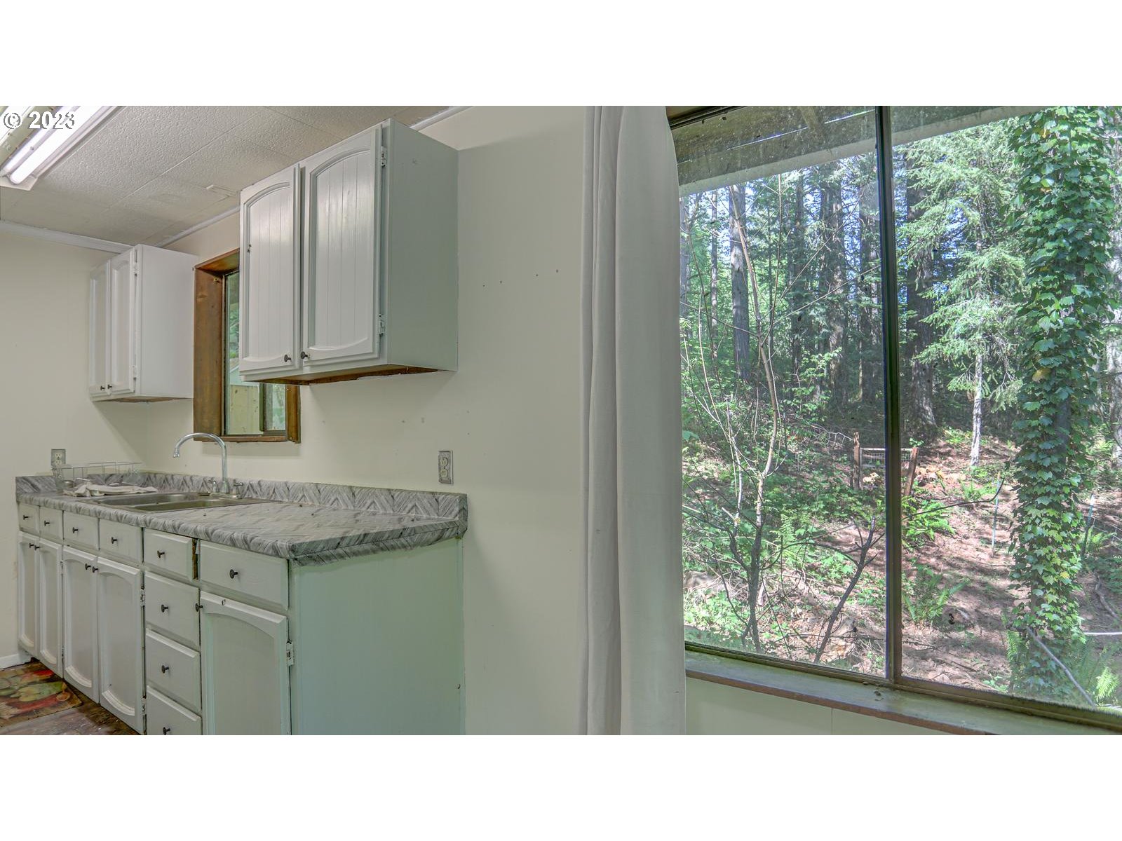 19830 South Hinkle Road Oregon City, OR 97045 - Photo 18 of 47 a kitchen with a sink window and cabinets