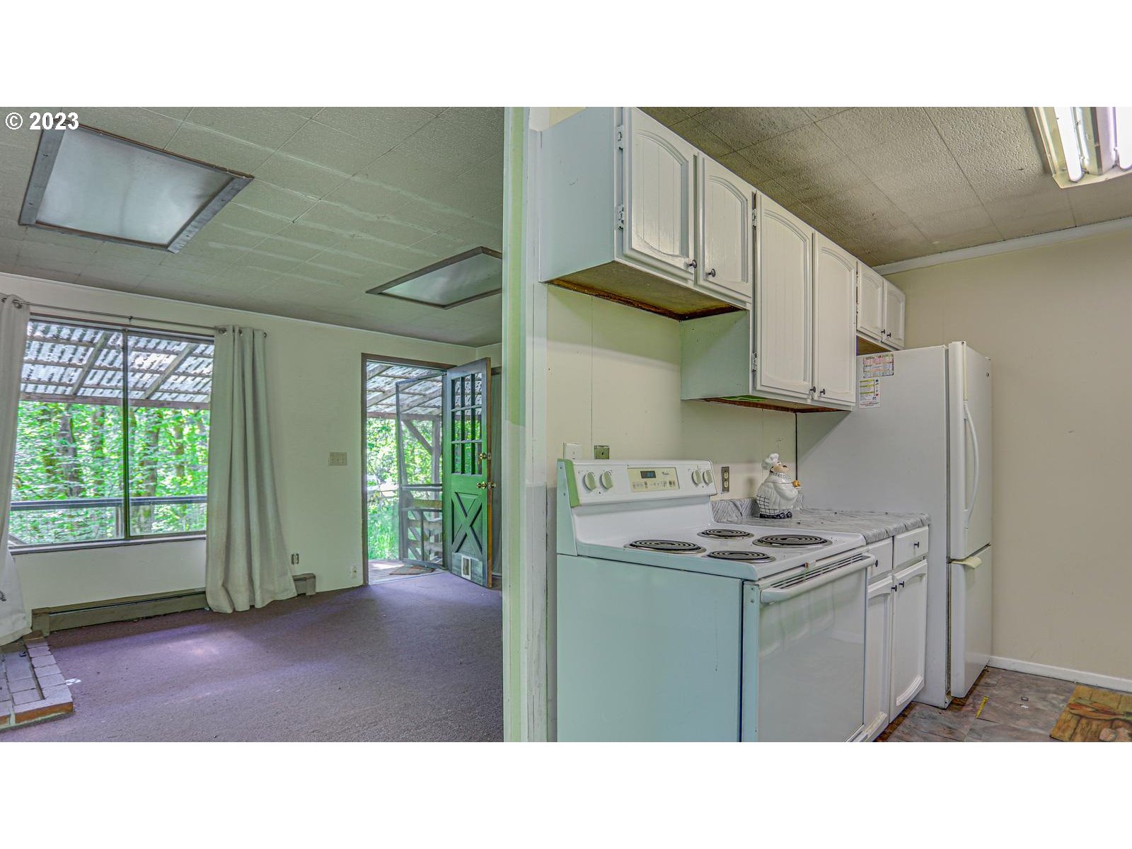 19830 South Hinkle Road Oregon City, OR 97045 - Photo 19 of 47 a kitchen with stainless steel appliances a sink a stove a refrigerator cabinets and a window
