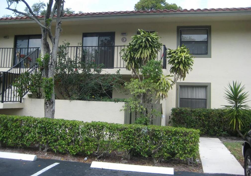 front view of a house with potted plants