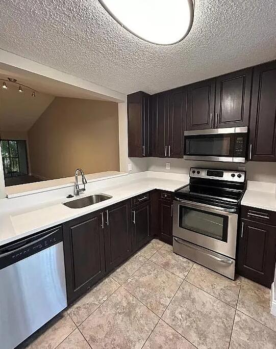 1999 Northwest 4th Avenue, Unit C Boca Raton, FL 33432 - Photo 3 of 4 a kitchen with sink cabinets and stainless steel appliances