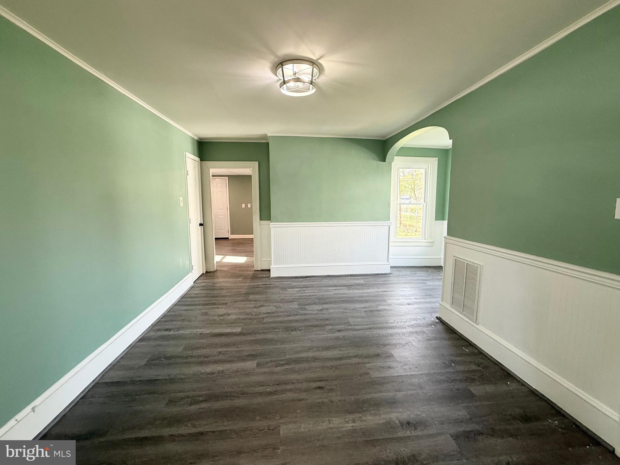 305 Central Avenue Ridgely, MD 21660 - Photo 6 of 19 a view of room with window and wooden floor