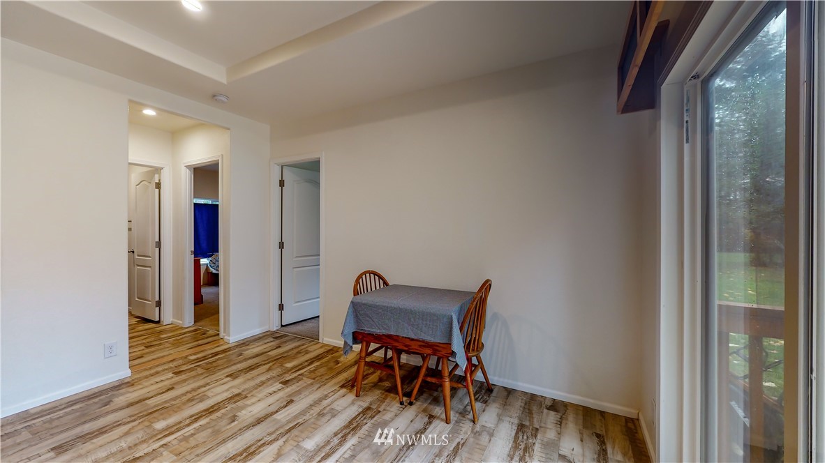 729 Cinebar Road, Unit A Cinebar, WA 98533 - Photo 12 of 30 a view of a hallway with wooden floor and a bathroom