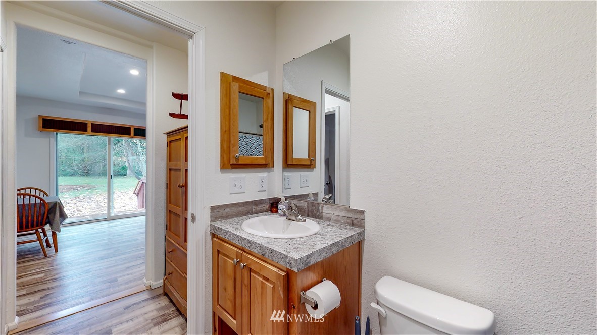 729 Cinebar Road, Unit A Cinebar, WA 98533 - Photo 13 of 30 a bathroom with a toilet a sink and a mirror