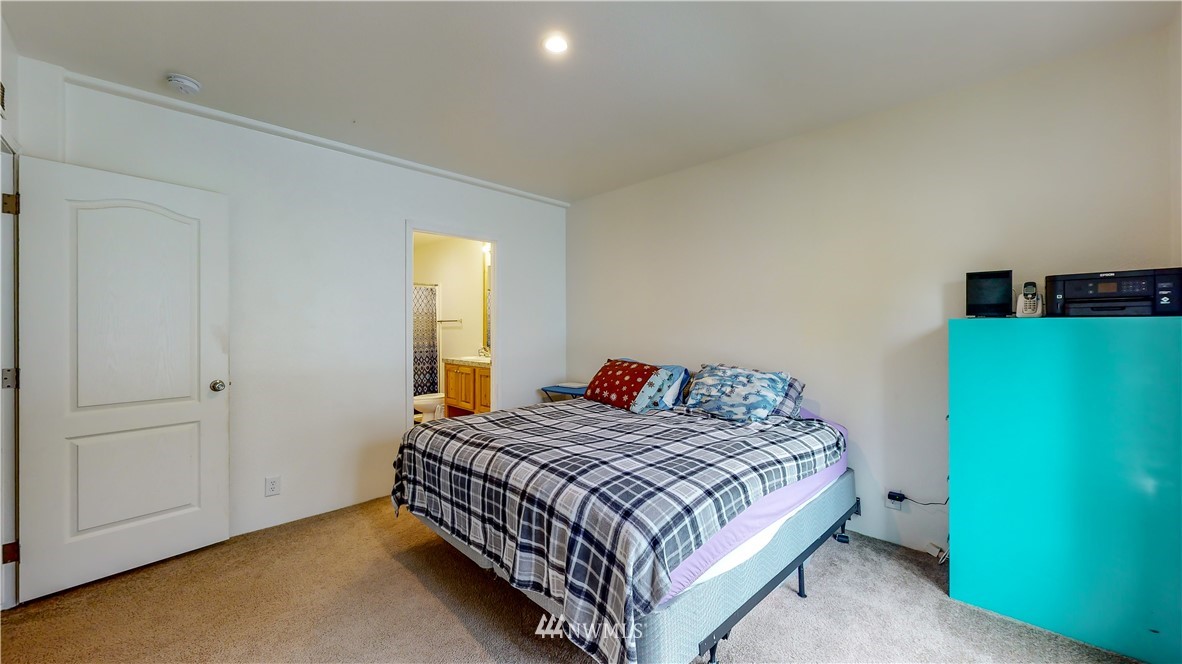 729 Cinebar Road, Unit A Cinebar, WA 98533 - Photo 18 of 30 a bedroom with a bed and a table in it