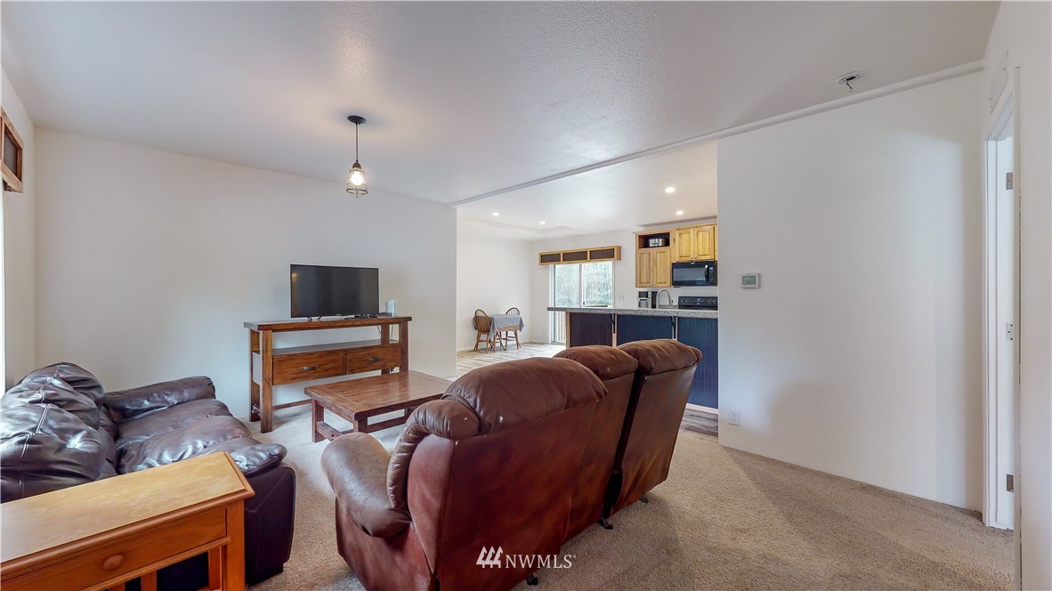 729 Cinebar Road, Unit A Cinebar, WA 98533 - Photo 3 of 30 a living room with furniture a ceiling fan and a window
