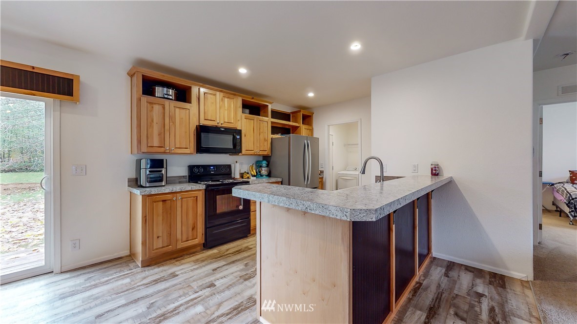 729 Cinebar Road, Unit A Cinebar, WA 98533 - Photo 8 of 30 a kitchen with stainless steel appliances granite countertop a sink stove and refrigerator