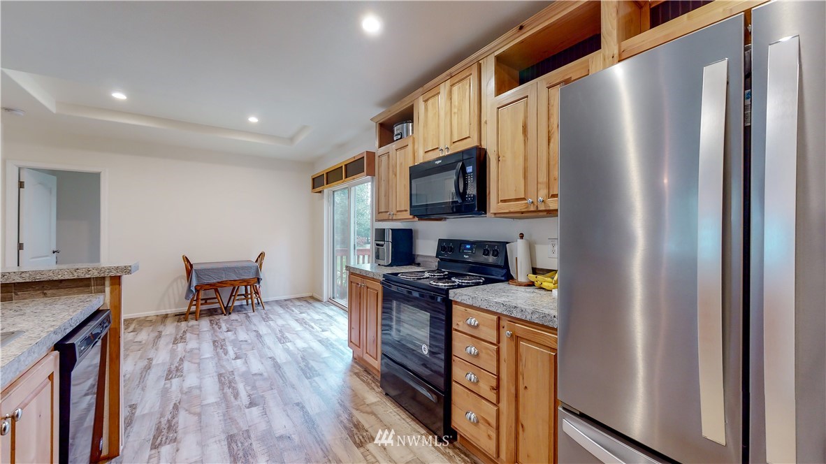 729 Cinebar Road, Unit A Cinebar, WA 98533 - Photo 9 of 30 a kitchen with stainless steel appliances granite countertop a refrigerator a stove top oven a sink and dishwasher